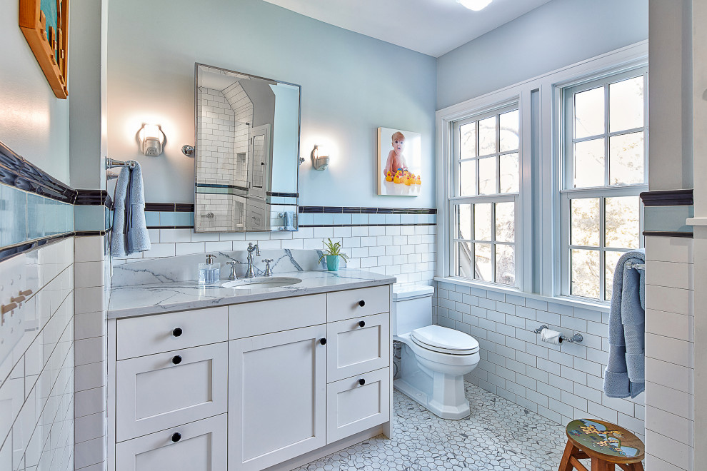 Mid-sized kids bathroom in Kansas City with shaker cabinets, white cabinets, white tile, porcelain tile, grey walls, porcelain floors, an undermount sink, engineered quartz benchtops, multi-coloured floor, a hinged shower door, blue benchtops, a shower seat, a single vanity and a built-in vanity.