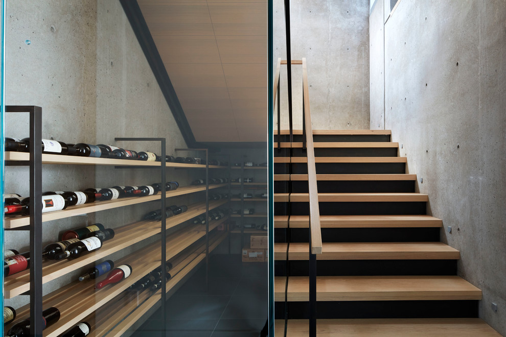 Design ideas for a mid-sized contemporary wine cellar in Vancouver with concrete floors and storage racks.