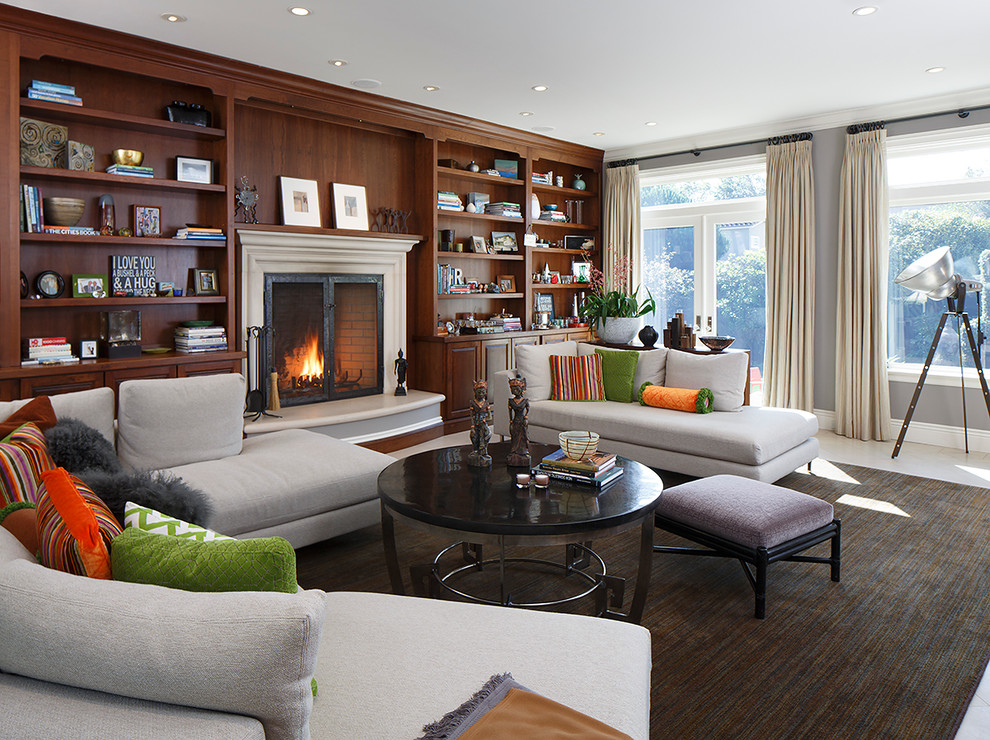 Example of a large classic formal and enclosed living room design in San Francisco with gray walls, a standard fireplace, a wood fireplace surround and no tv
