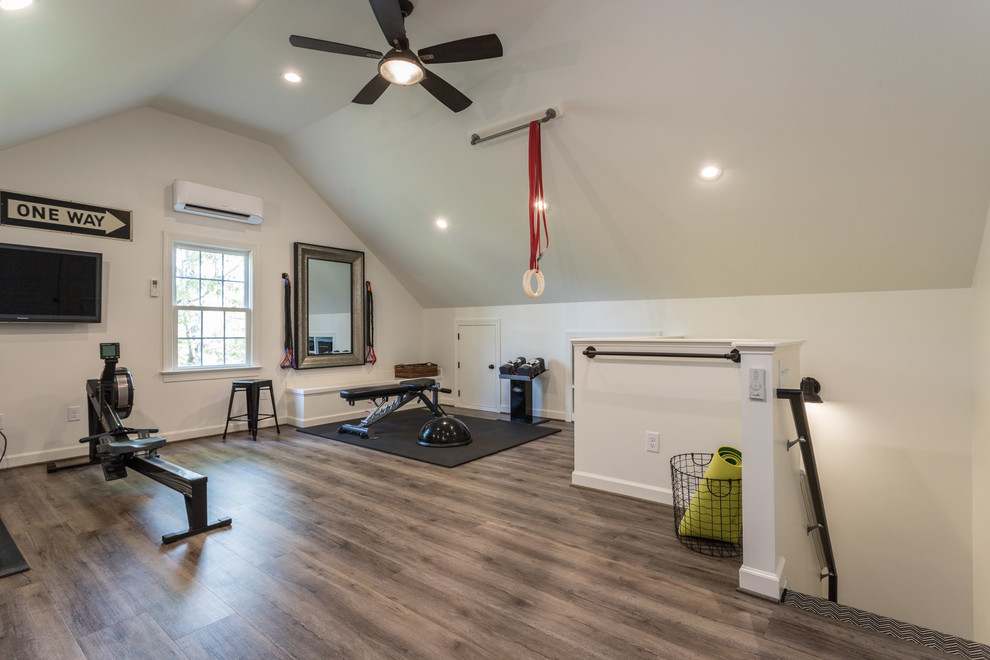 This is an example of an expansive transitional multipurpose gym in Raleigh with white walls, vinyl floors and brown floor.