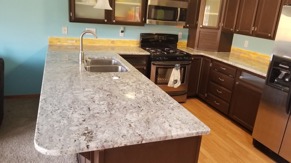Kitchen in Seattle with an undermount sink, granite benchtops and a peninsula.