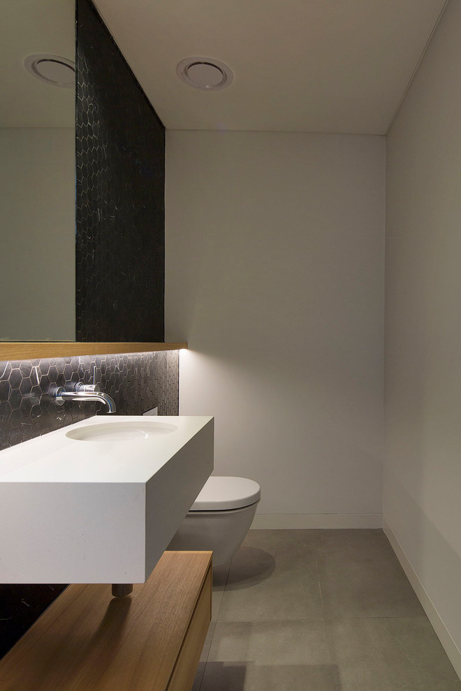 Design ideas for a modern powder room in Sydney with black tile and marble.