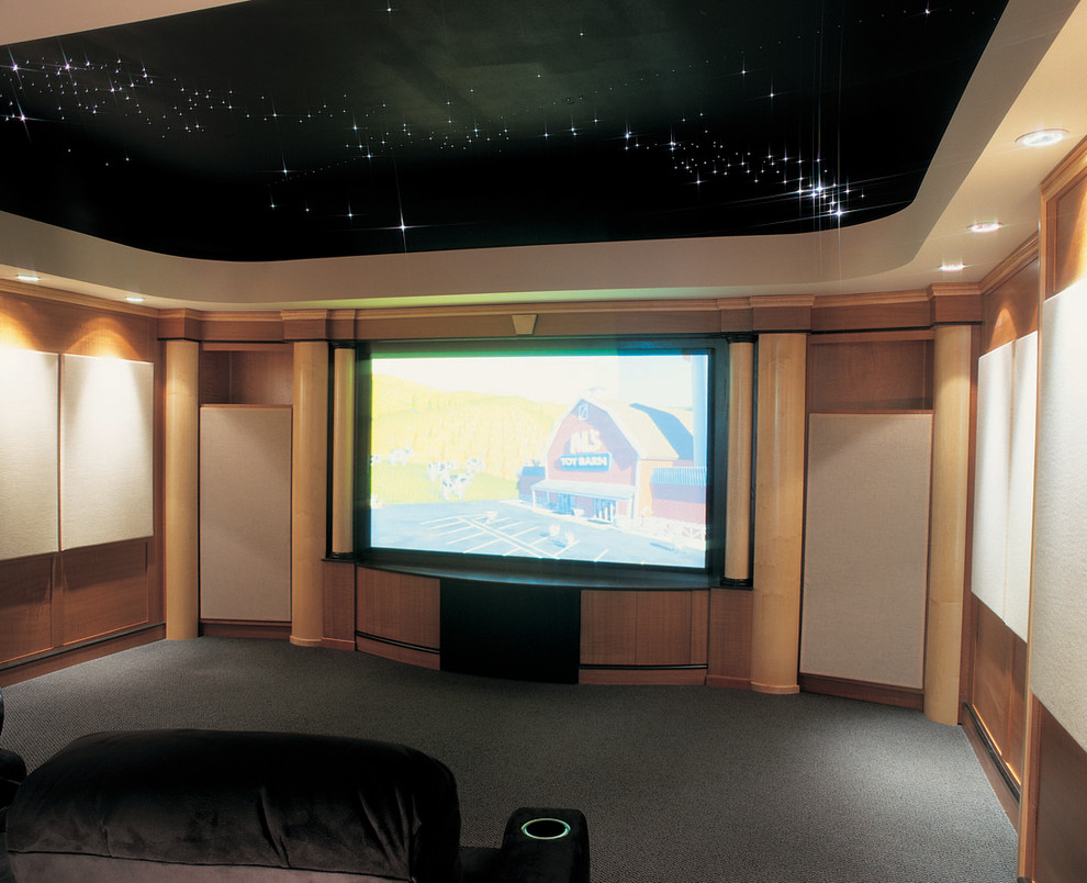 Large traditional enclosed home theatre in Philadelphia with beige walls, carpet and a built-in media wall.