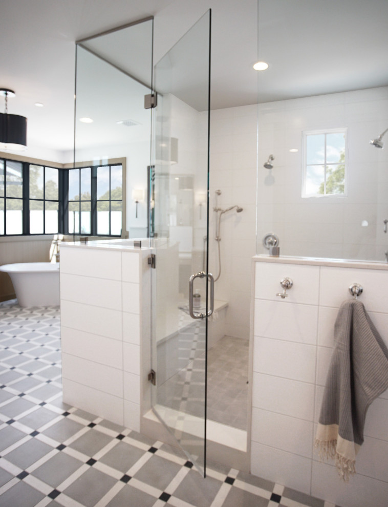 This is an example of a large transitional master bathroom with furniture-like cabinets, beige cabinets, a freestanding tub, a double shower, white tile, subway tile, white walls, cement tiles, an undermount sink, engineered quartz benchtops, multi-coloured floor, a hinged shower door, grey benchtops, an enclosed toilet, a double vanity, a built-in vanity and wood walls.