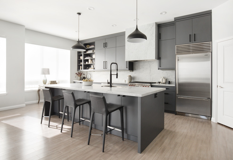 Inspiration for a mid-sized contemporary galley eat-in kitchen in Salt Lake City with an undermount sink, flat-panel cabinets, marble benchtops, grey splashback, marble splashback, stainless steel appliances, light hardwood floors, with island, grey benchtop, grey cabinets and beige floor.