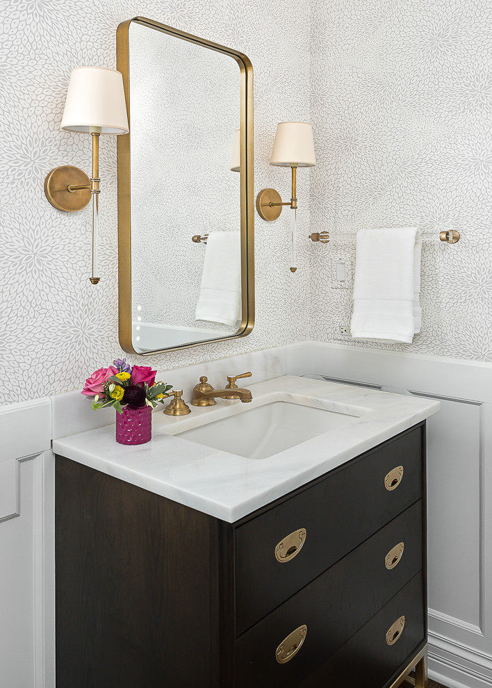 Small transitional powder room photo in Chicago with flat-panel cabinets, dark wood cabinets, an undermount sink and marble countertops