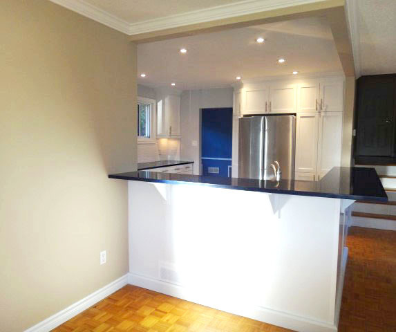 Eat-in kitchen - large transitional u-shaped eat-in kitchen idea in Toronto with recessed-panel cabinets, white cabinets, quartzite countertops, white backsplash, subway tile backsplash, blue countertops and stainless steel appliances