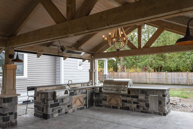 Inspiration for an arts and crafts backyard patio in Vancouver with an outdoor kitchen, stamped concrete and a gazebo/cabana.