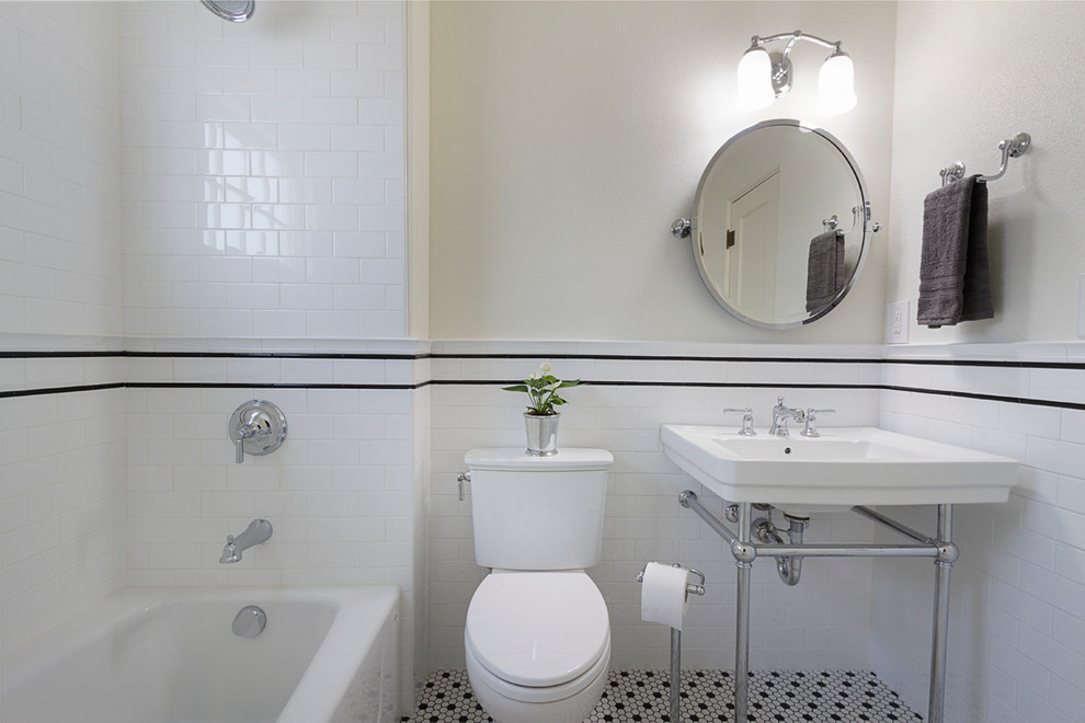 Small arts and crafts 3/4 bathroom in Phoenix with an alcove tub, a shower/bathtub combo, a two-piece toilet, black and white tile, subway tile, white walls, ceramic floors, a console sink and multi-coloured floor.