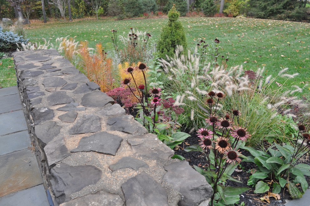 Modern front yard full sun formal garden in Boston with a garden path and natural stone pavers.