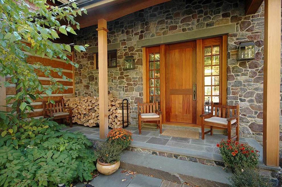 Inspiration for a country front door in Burlington with brown walls, a single front door and a medium wood front door.