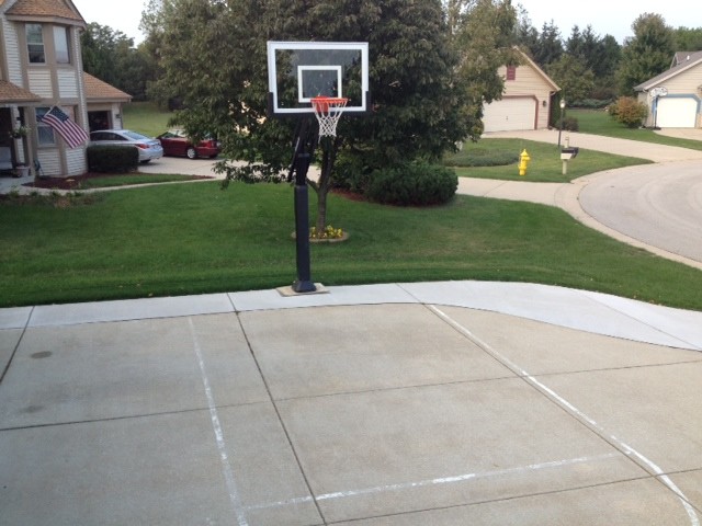 Photo of a large traditional front yard partial sun outdoor sport court in Milwaukee.