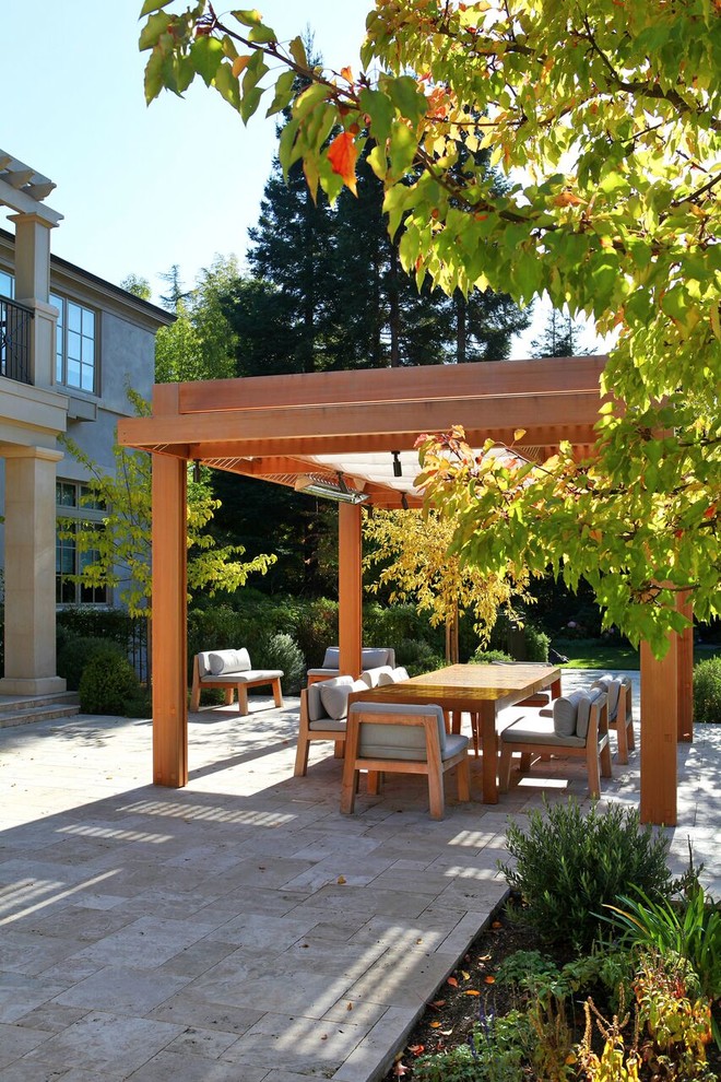 This is an example of a large contemporary backyard patio in San Francisco with tile and a pergola.