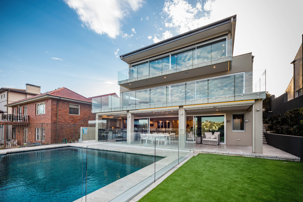 Large modern balcony in Sydney with no cover and glass railing.