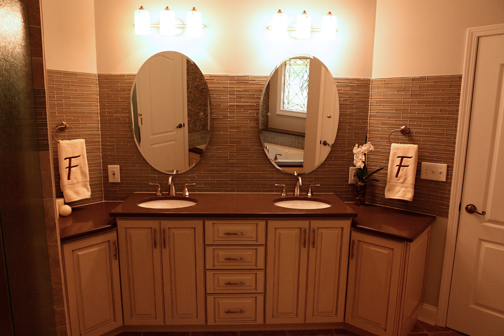 This is an example of a small contemporary master bathroom in Orange County with raised-panel cabinets, beige cabinets, beige walls, porcelain floors, an undermount sink, a corner tub and an alcove shower.
