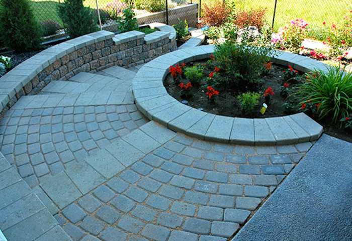 Photo of a mid-sized transitional shade backyard brick landscaping in Calgary with no cover for spring.