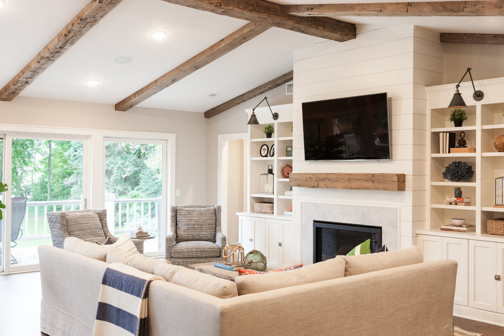 Design ideas for a large beach style open concept family room in Minneapolis with grey walls, dark hardwood floors, a standard fireplace, a stone fireplace surround and a wall-mounted tv.