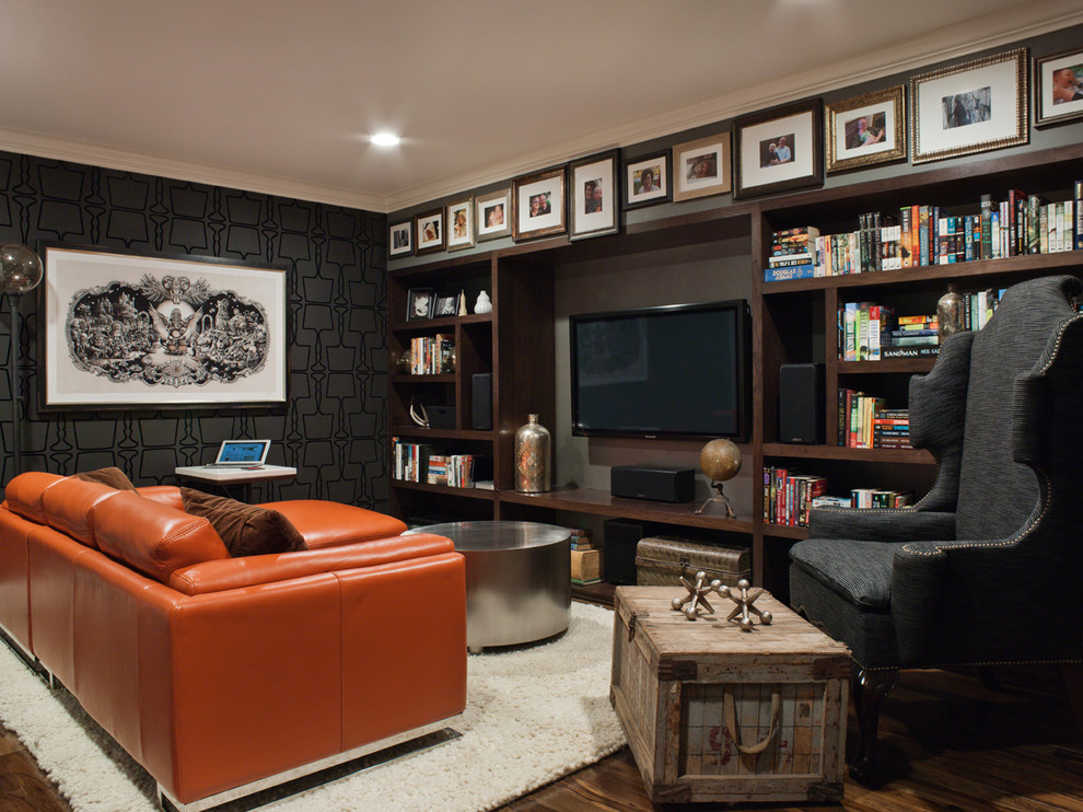 Inspiration for a mid-sized transitional enclosed family room in San Francisco with black walls, a wall-mounted tv, dark hardwood floors and brown floor.
