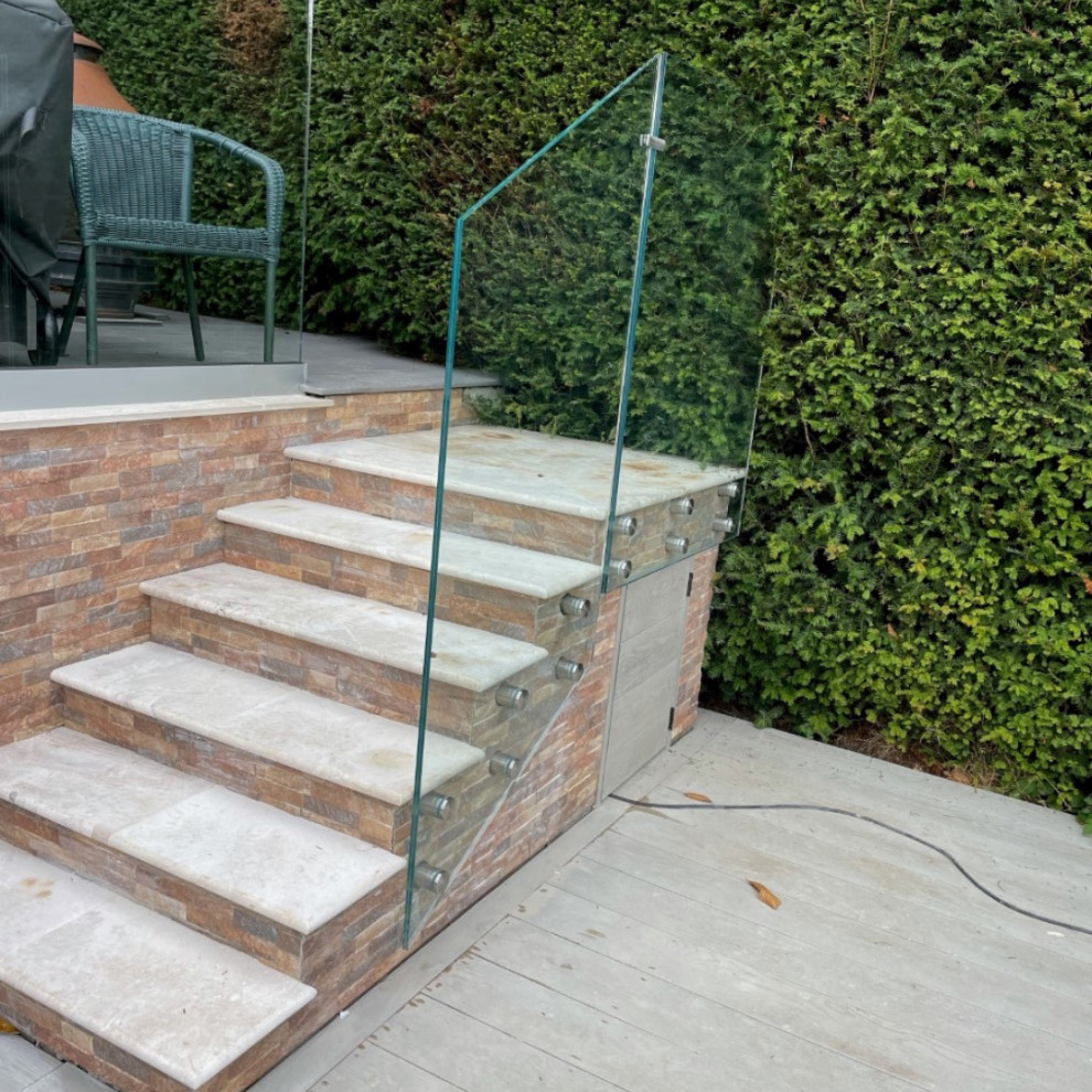 This is an example of a small modern glass straight staircase in Other with glass risers and glass railing.
