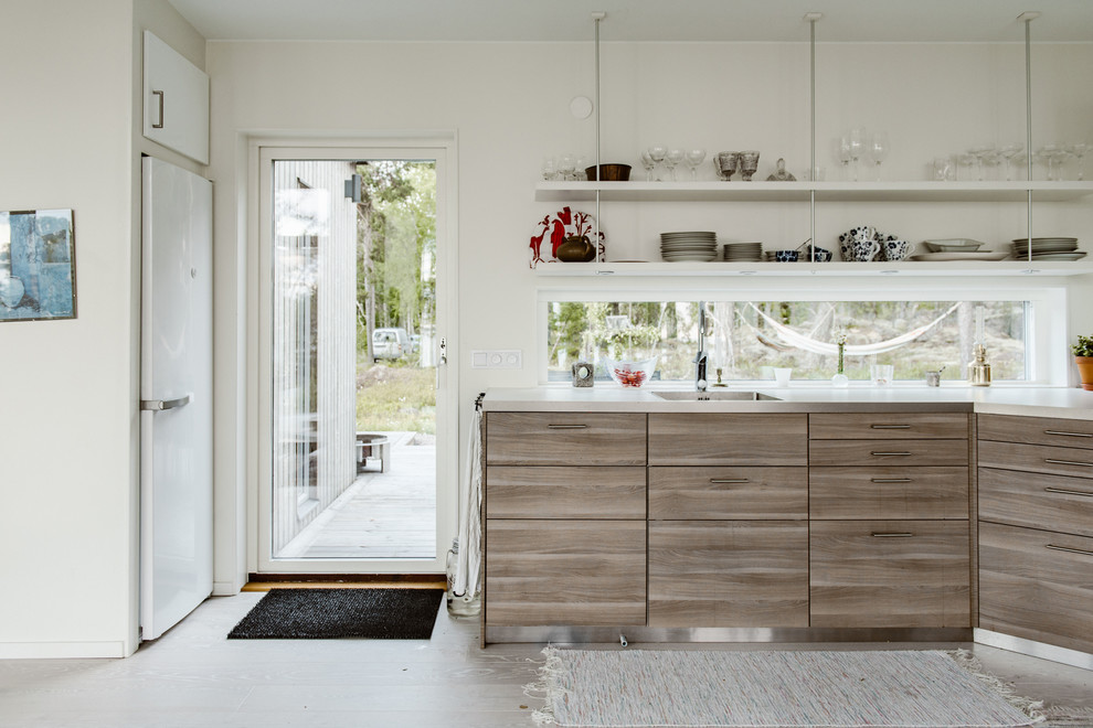 Photo of a mid-sized scandinavian kitchen in Stockholm with flat-panel cabinets, distressed cabinets and no island.