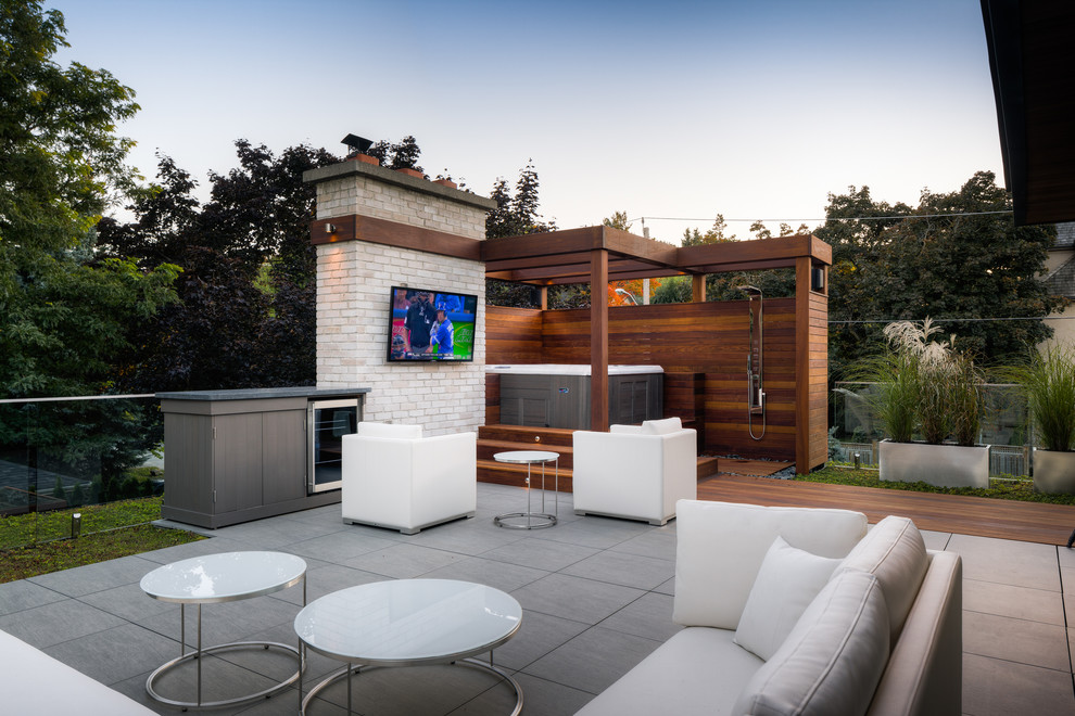 Inspiration for a mid-sized contemporary backyard patio in Toronto with decking, a pergola and an outdoor shower.