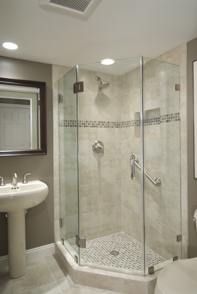 Inspiration for a mid-sized transitional 3/4 beige tile and ceramic tile ceramic tile and beige floor corner shower remodel in Toronto with gray walls, a pedestal sink, a two-piece toilet and a hinged shower door