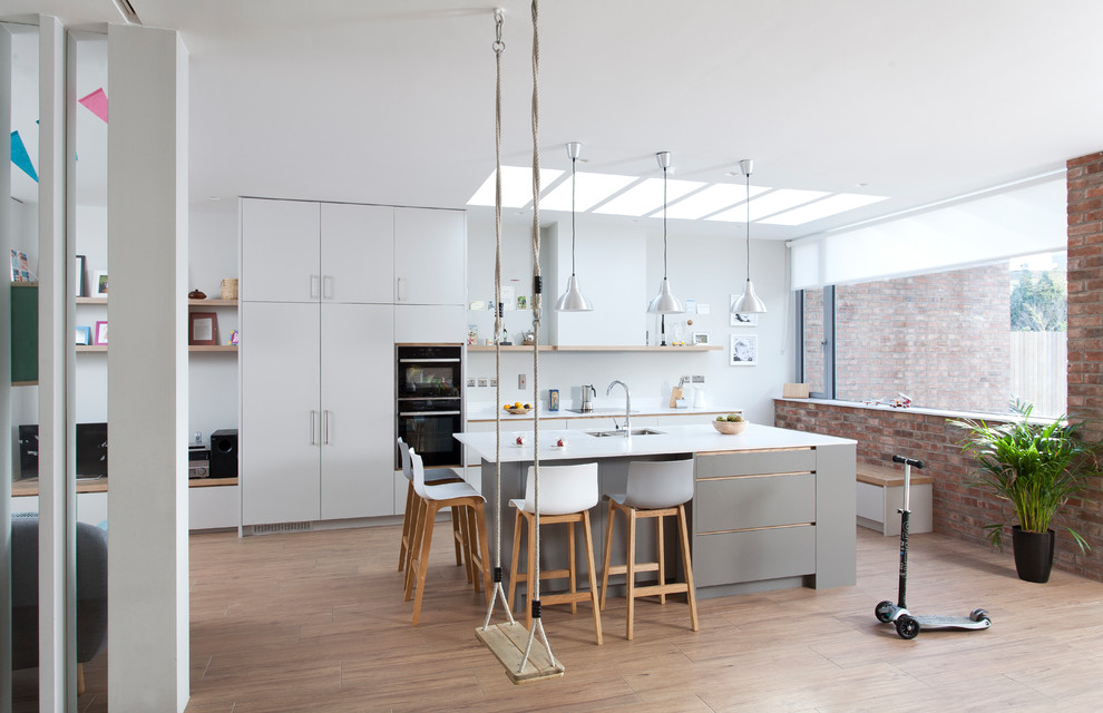 Photo of a mid-sized contemporary open plan kitchen in Dublin with with island.