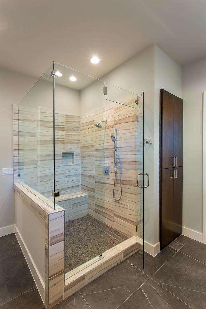 This is an example of a mid-sized modern master bathroom in Dallas with recessed-panel cabinets, white cabinets, a freestanding tub, a corner shower, gray tile, grey walls, ceramic floors, an undermount sink, solid surface benchtops, grey floor and a hinged shower door.
