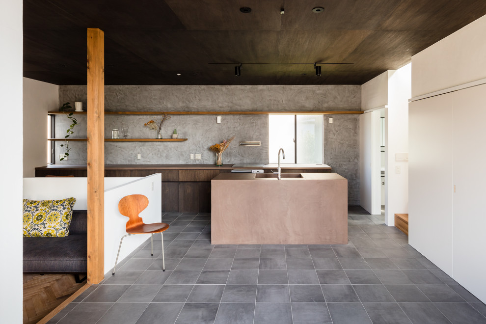 Large contemporary l-shaped kitchen in Other with an undermount sink, flat-panel cabinets, medium wood cabinets, grey splashback, panelled appliances, with island, grey floor and brown benchtop.