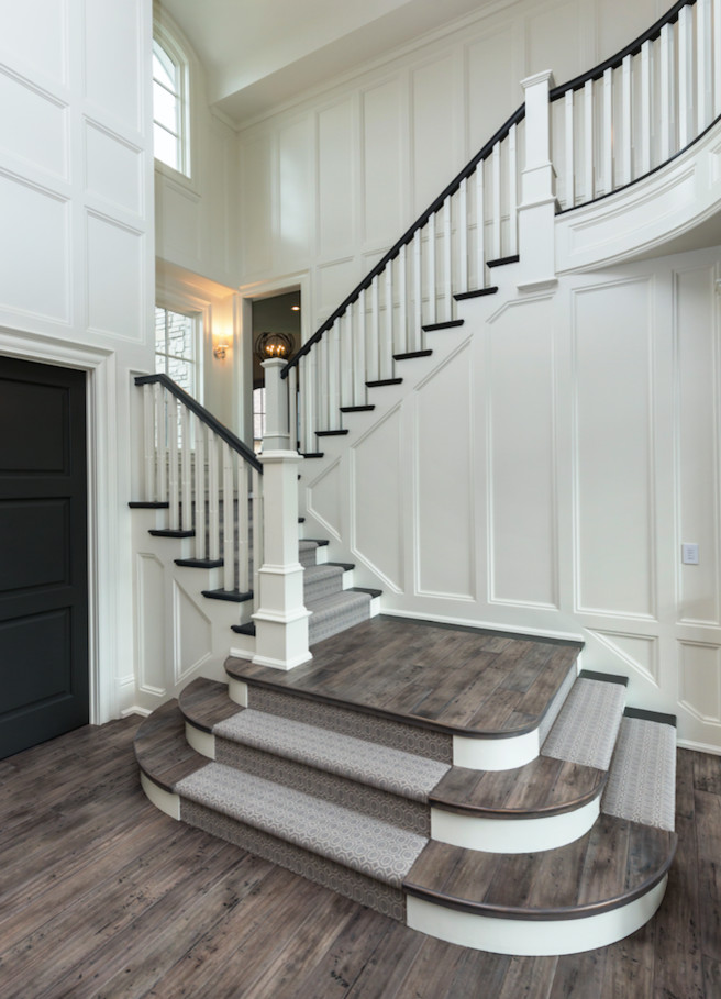 Large traditional wood curved staircase in Other.