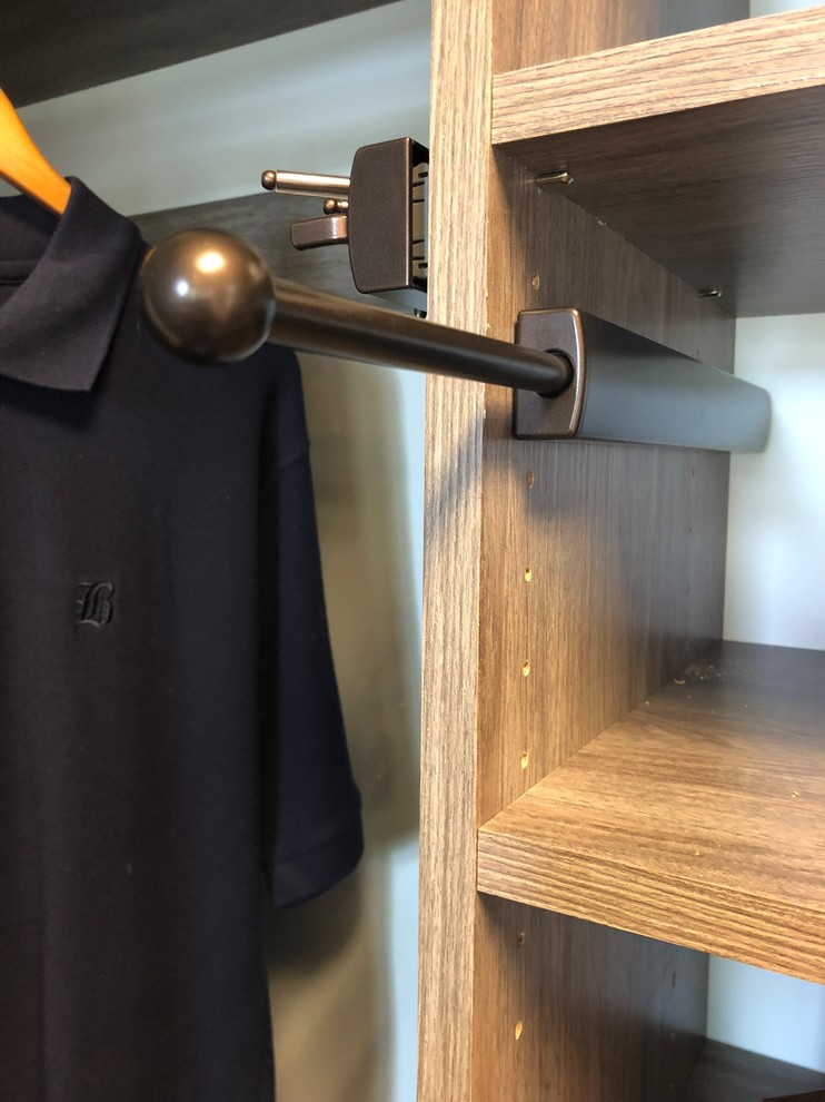 Inspiration for a transitional carpeted walk-in closet remodel with flat-panel cabinets and gray cabinets