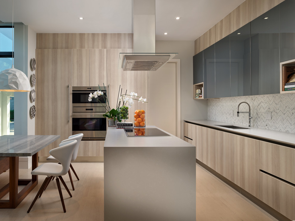 Design ideas for a mid-sized contemporary l-shaped eat-in kitchen in Miami with a double-bowl sink, flat-panel cabinets, multi-coloured splashback, stainless steel appliances, with island, beige floor and beige cabinets.