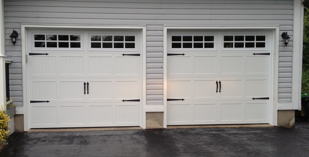 Design ideas for a mid-sized traditional attached two-car garage in Other.
