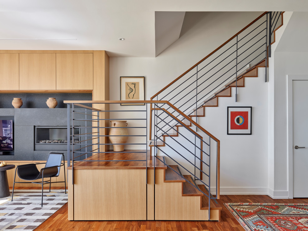 This is an example of a small contemporary wood u-shaped staircase in Philadelphia with wood risers and metal railing.