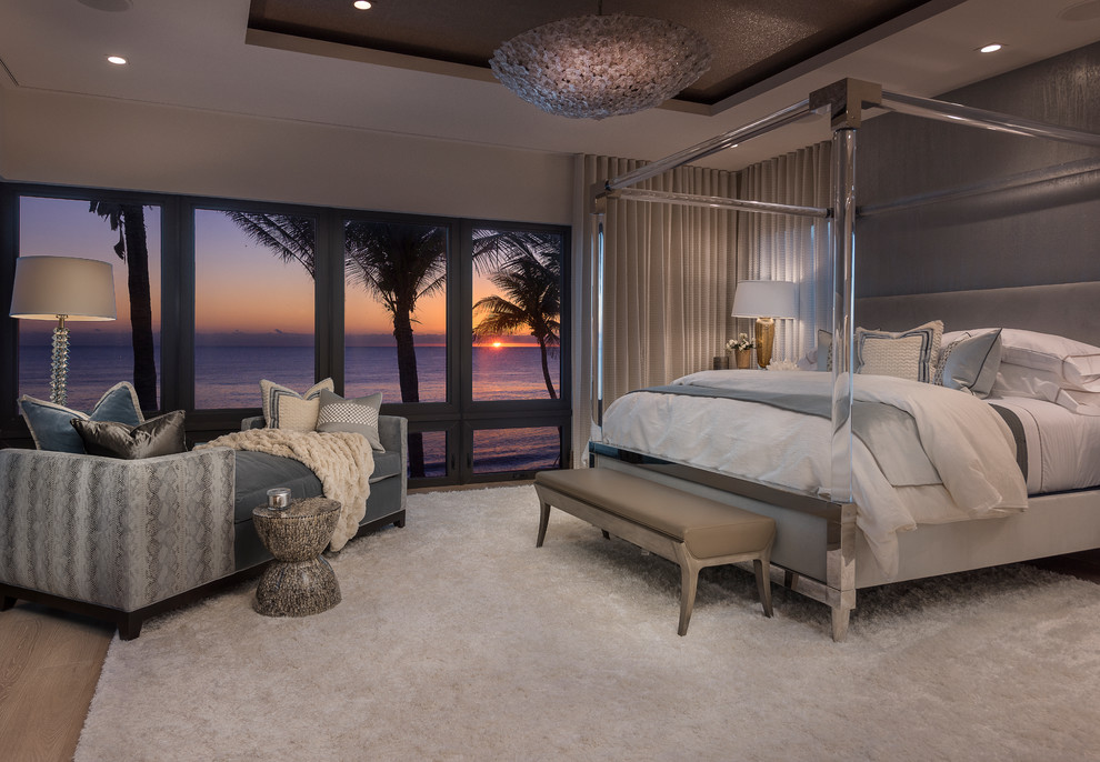 Inspiration for a transitional bedroom in Miami with beige walls, light hardwood floors and beige floor.