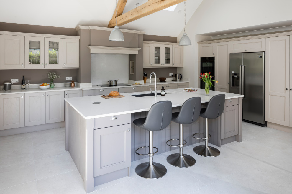 Photo of a mid-sized country l-shaped separate kitchen in Surrey with with island.
