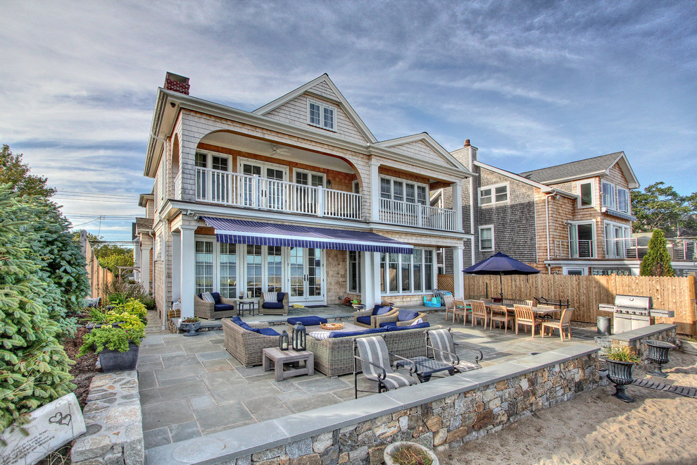 Design ideas for a large beach style two-storey brown exterior in Other with wood siding.
