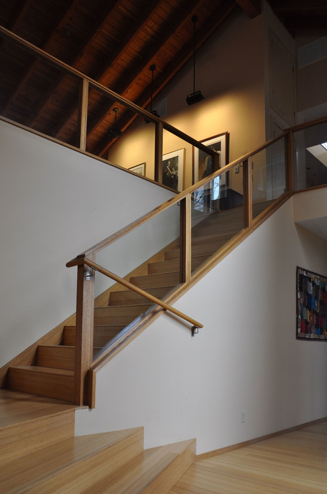 Photo of a large transitional wood straight staircase in Phoenix with wood risers.