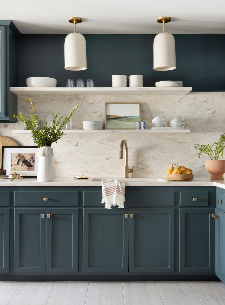 Inspiration for a small transitional l-shaped eat-in kitchen in Minneapolis with an integrated sink, recessed-panel cabinets, blue cabinets, solid surface benchtops, beige splashback, porcelain floors, no island, grey floor and beige benchtop.