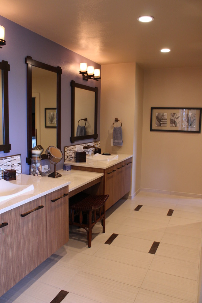 Photo of a mid-sized contemporary master bathroom in Denver with a drop-in sink, flat-panel cabinets, engineered quartz benchtops, a drop-in tub, porcelain tile and porcelain floors.