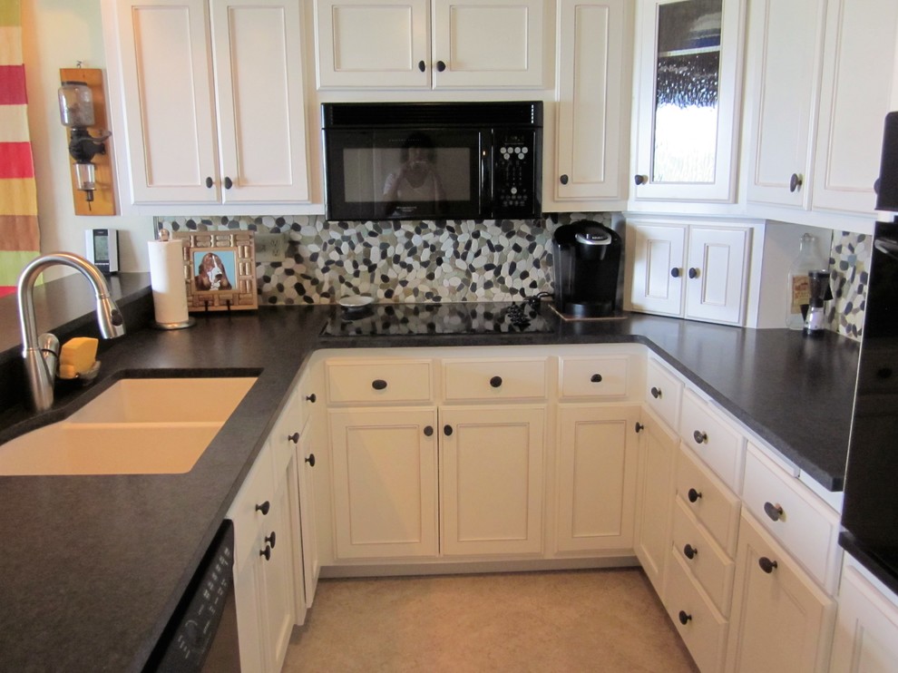 Large transitional u-shaped ceramic tile eat-in kitchen photo in Milwaukee with a double-bowl sink, raised-panel cabinets, white cabinets, laminate countertops, multicolored backsplash, stone tile backsplash, stainless steel appliances and no island
