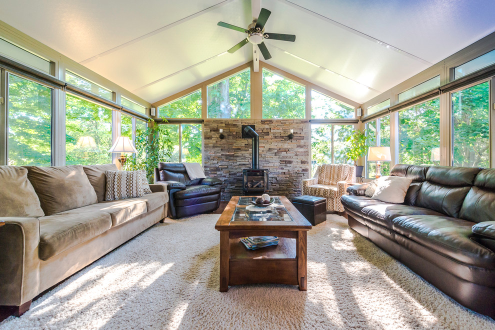 Inspiration for a mid-sized transitional sunroom in Other with medium hardwood floors, a wood stove, a metal fireplace surround, a standard ceiling and brown floor.