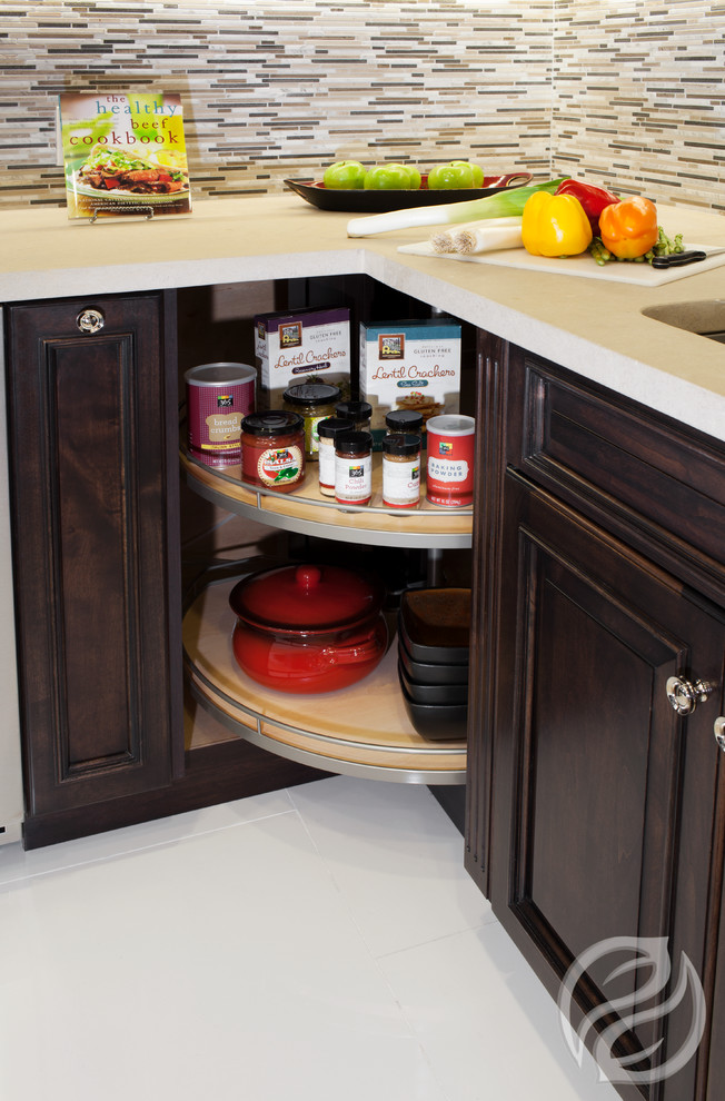 Open concept kitchen - mid-sized transitional l-shaped porcelain tile open concept kitchen idea in Chicago with an undermount sink, raised-panel cabinets, dark wood cabinets, quartz countertops, multicolored backsplash, glass tile backsplash, stainless steel appliances and an island