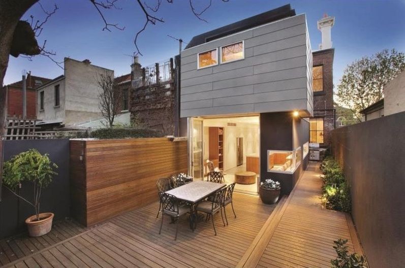 Photo of a mid-sized contemporary two-storey black exterior in Melbourne with metal siding and a flat roof.