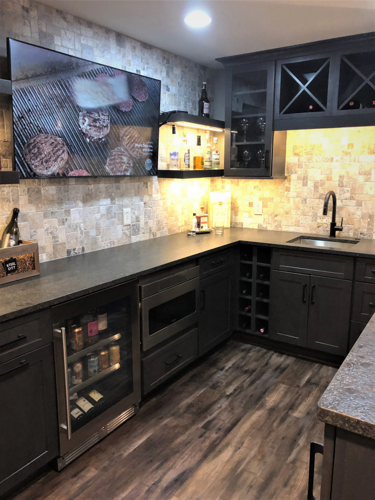 Design ideas for a small rustic u-shaped wet bar in Other with a submerged sink, flat-panel cabinets, dark wood cabinets, granite worktops, grey splashback, travertine splashback, vinyl flooring, brown floors and brown worktops.