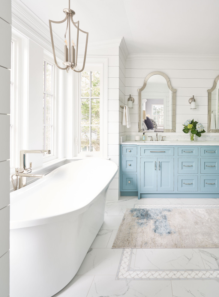 Design ideas for a medium sized traditional ensuite bathroom in Wilmington with a freestanding bath, medium hardwood flooring, marble worktops, a hinged door, an enclosed toilet, double sinks and a built in vanity unit.