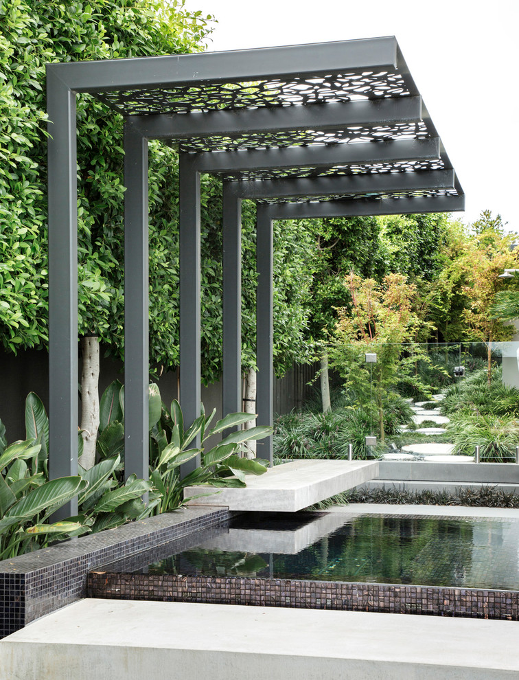This is an example of a contemporary side yard garden in Melbourne with with pond and concrete pavers.