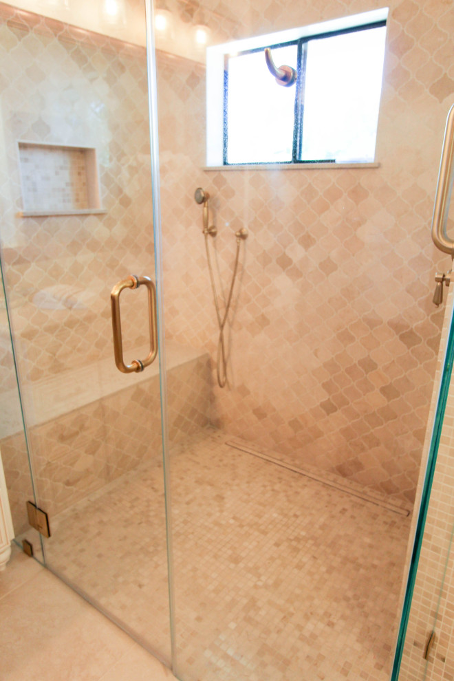 Photo of a large traditional master bathroom in San Francisco with recessed-panel cabinets, white cabinets, a freestanding tub, a curbless shower, a one-piece toilet, beige tile, porcelain tile, white walls, porcelain floors, an undermount sink, engineered quartz benchtops, beige floor, a hinged shower door, beige benchtops, a shower seat, a double vanity, a built-in vanity, coffered and decorative wall panelling.