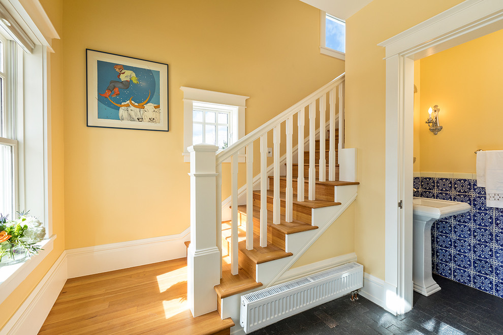 Medium sized classic wood l-shaped wood railing staircase in Albuquerque with wood risers.