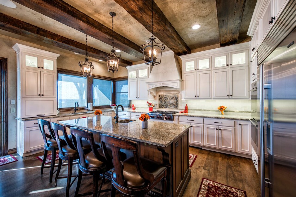 Inspiration for a large rustic u-shaped dark wood floor kitchen remodel with an undermount sink, beaded inset cabinets, white cabinets, granite countertops, white backsplash, stainless steel appliances and an island